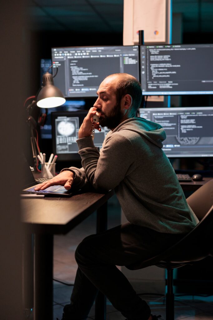 IT engineer answering landline phone call in office