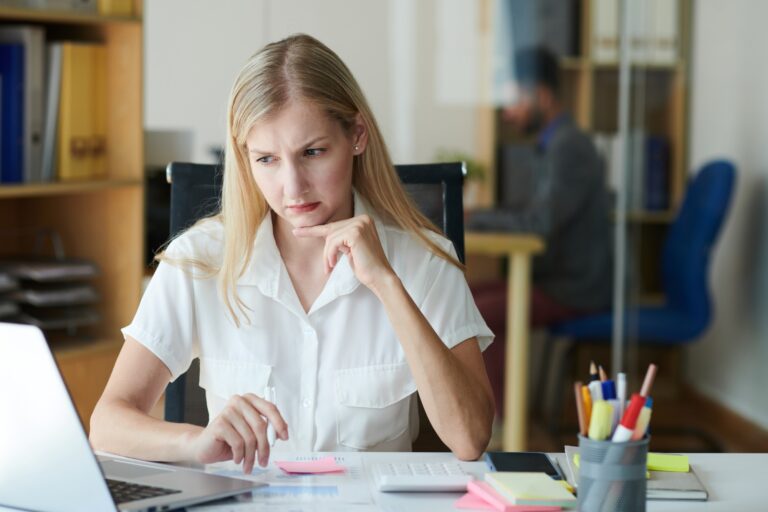 Frowning Businesswoman Reading E-mail