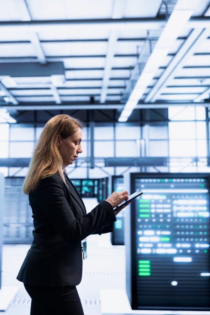 Software developer using tablet in data center with advanced tech