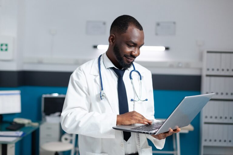 African american therapist doctor holding laptop computer looking at online medicine prescription