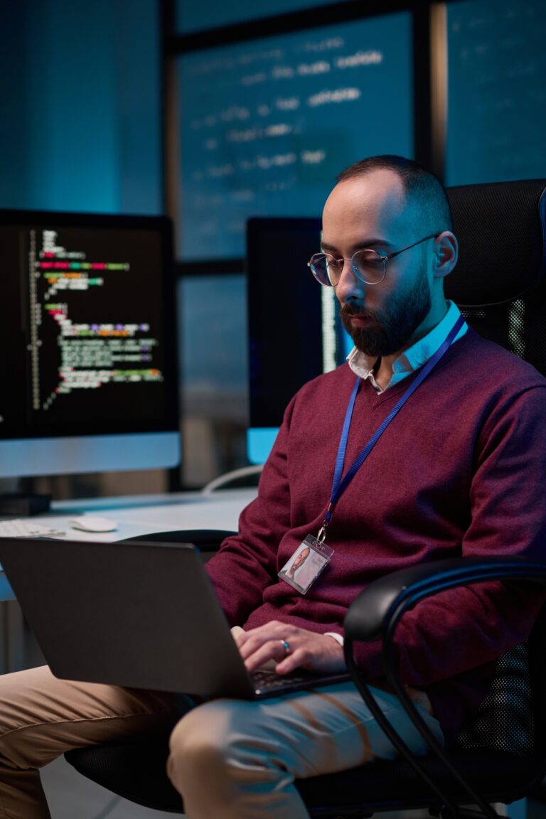 IT Developer using Laptop at Workplace