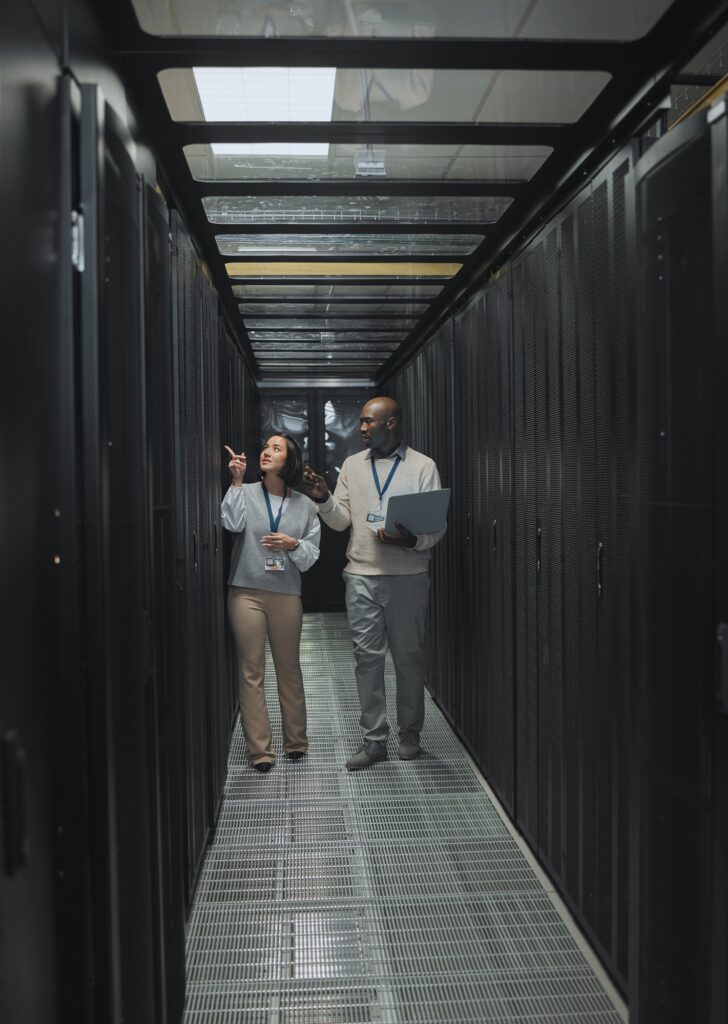Laptop, teamwork or IT people in server room for maintenance, analysis or digital innovation. Data