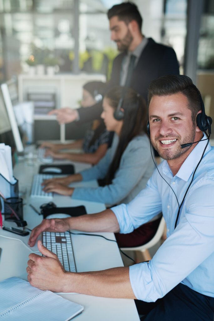 Support with a smile. Portrait of a happy and confident young man working in a call center.