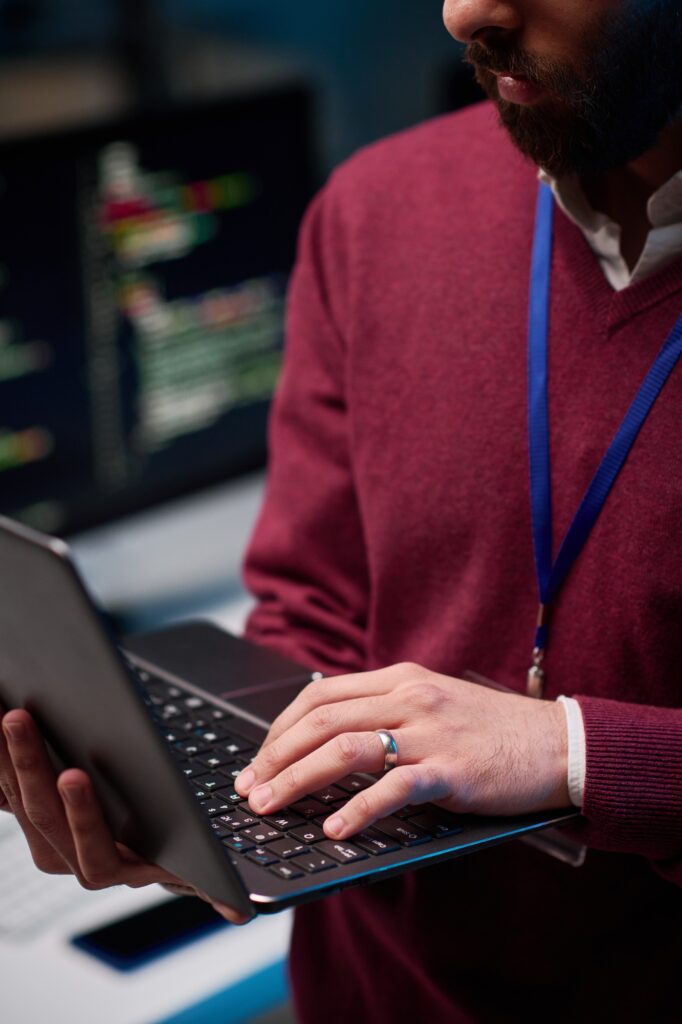 Close Up of Man Holding Open Laptop