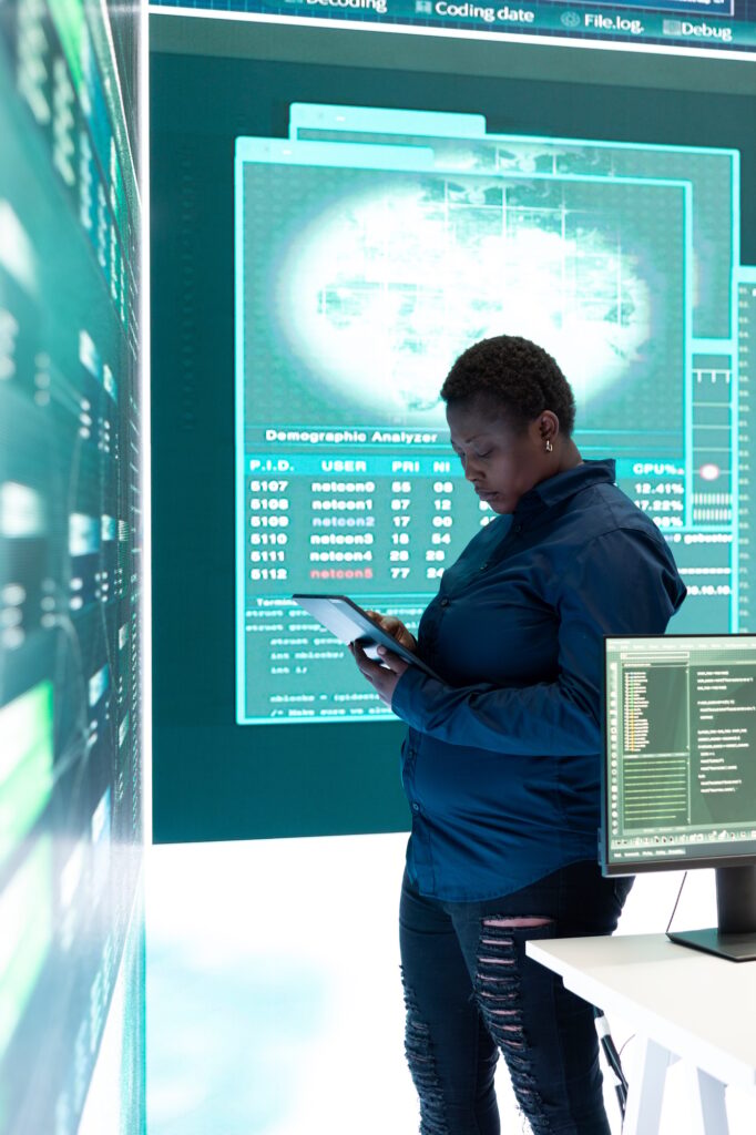 Governmental hacker woman working with a tablet and big screen