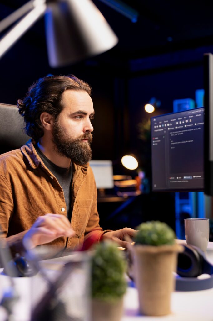 IT specialist typing on keyboard, writing code to build firewalls