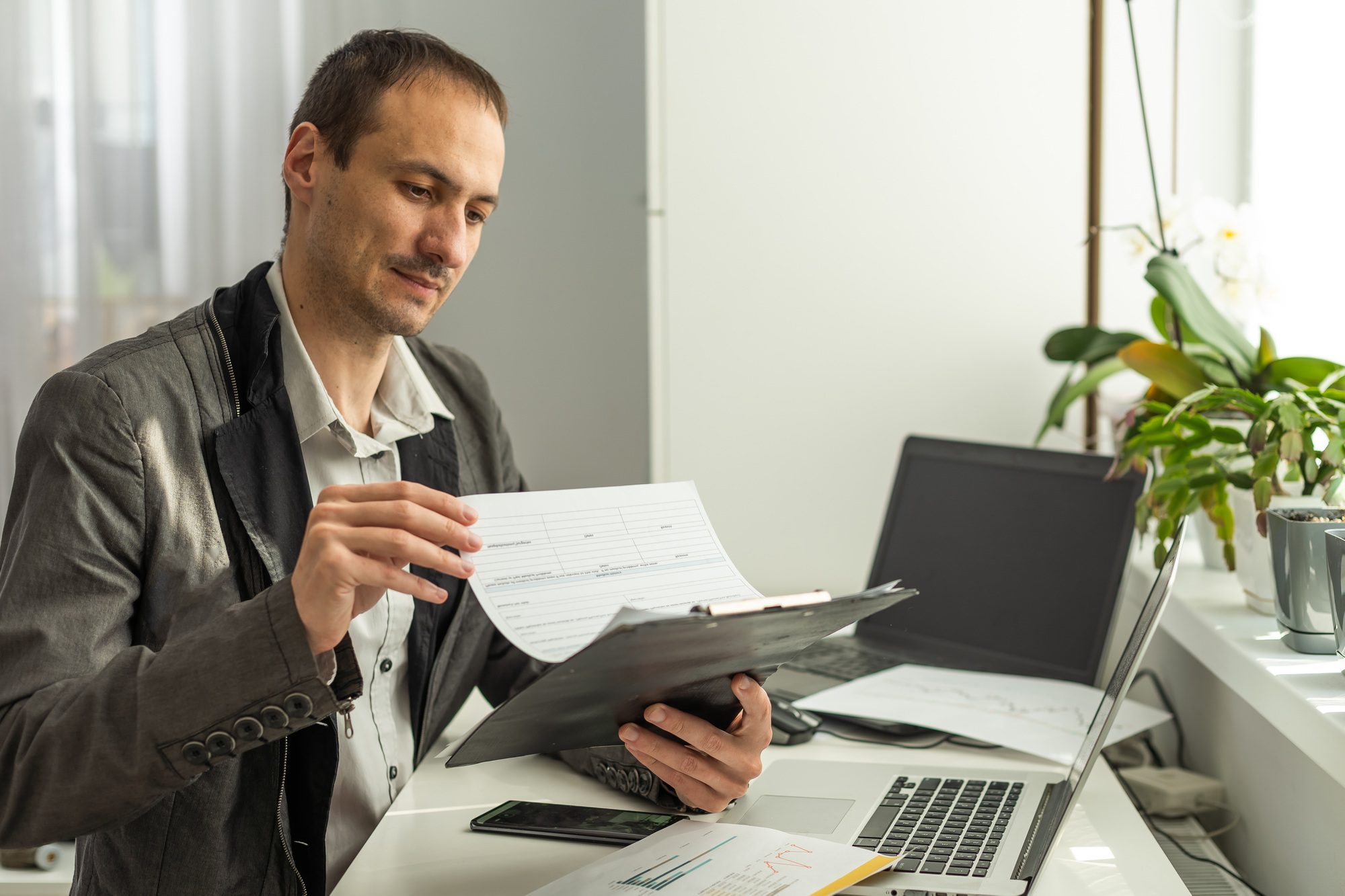 Upset stressed worried caucasian male stock investor, broker, financial expert, sit at work desk in