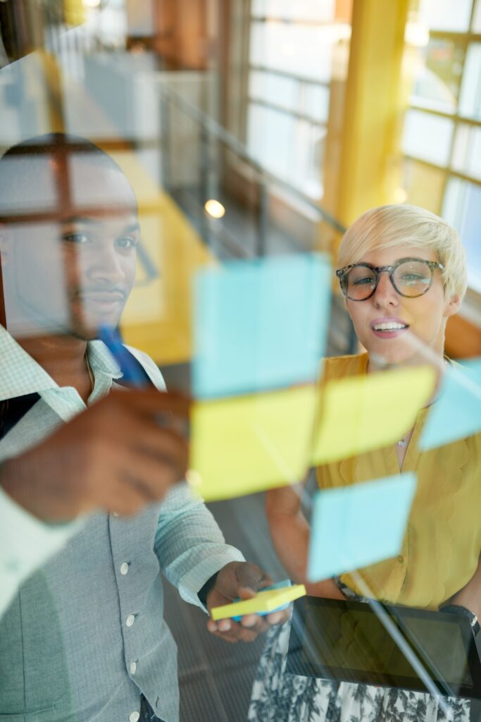 Two creative millenial small business owners working on social media strategy brainstorming